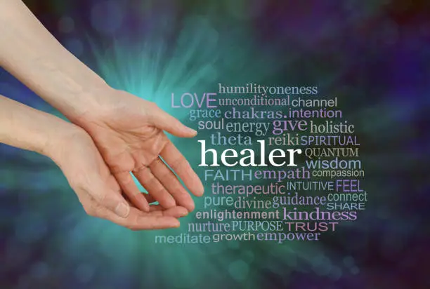 Female hands in open giving gesture beside a HEALER word cloud on a green and blue outwardly flowing bokeh background