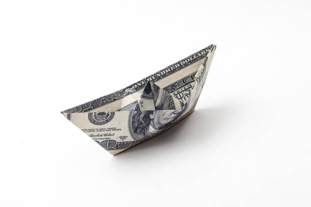ship made of us dollars on white backgrounds dollar boat making money origami stock pictures, royalty-free photos & images