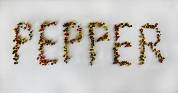 istock A pepper inscription on a white background, made with pepper. 673517234