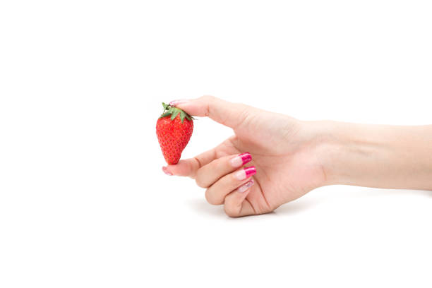 istock Fresh strawberries. holding strawberry in fingers 673520574