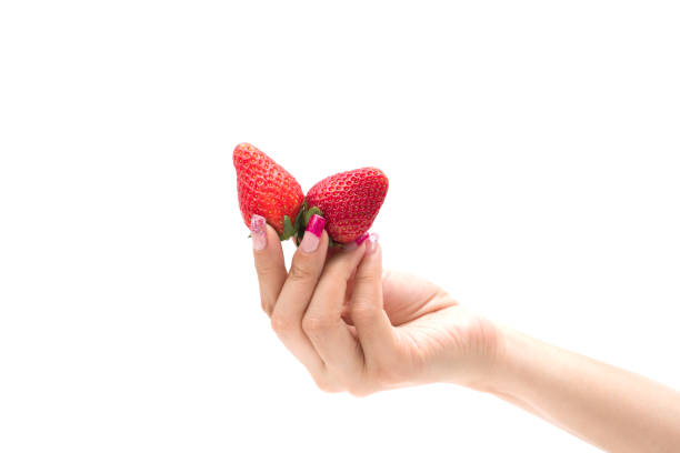 istock Fresh strawberries. holding strawberry in fingers 673520586