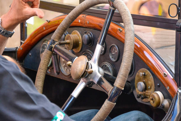 Male hands on vintage classic car steering wheel