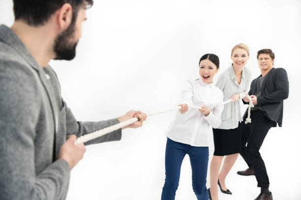 istock group of business people pulling over rope isolated on white 673524884