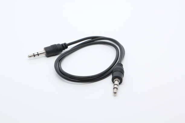 istock Close up of black audio cable aux isolated on white background 673526636
