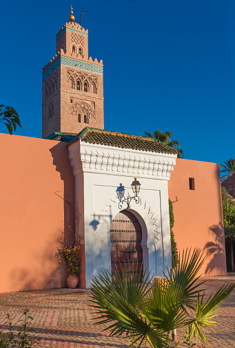 The Koutoubia Mosque or Kutubiyya Mosque, the largest mosque in Marrakesh, Morocco. Ornamented with curved windows, a band of ceramic inlay, pointed merlons, and decorative arches. Completed under the reign of the Berber Almohad Caliph Yaqub al-Mansur (1184 to 1199), and has inspired other buildings such as the Giralda of Seville and the Hassan Tower of Rabat.