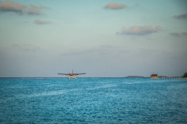 The takeoff of a seaplane from the ocean beach.