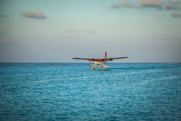 The takeoff of a seaplane from the ocean beach.