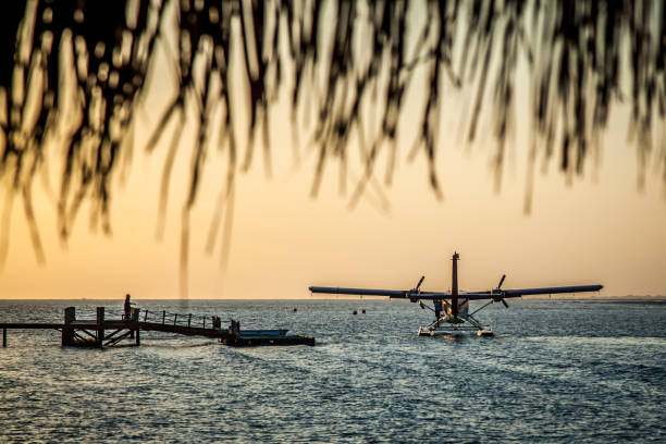 The takeoff of a seaplane from the ocean beach.