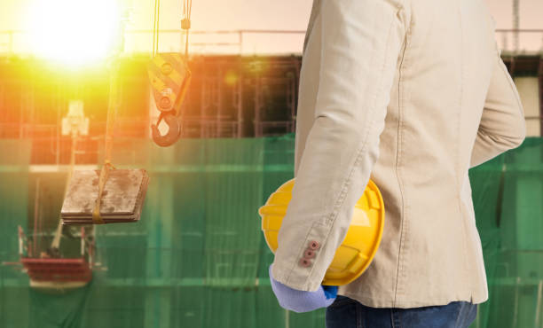istock Constuction manager holding safety helmet looking at him construction works 673539358