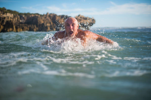 istock Handsome senior man in ocean 673542420