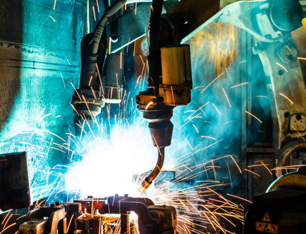 istock Welding robots movement in a car factory 673542424