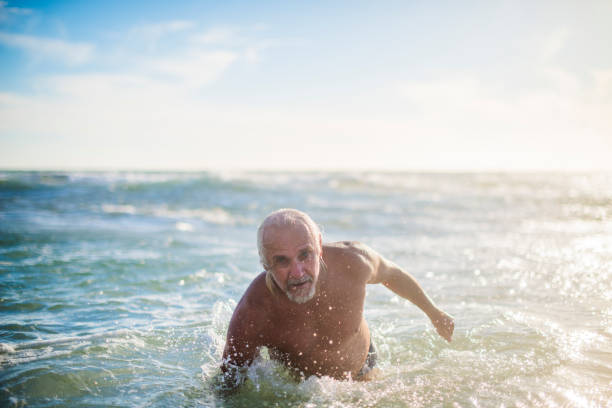 istock Handsome senior man in ocean 673542492