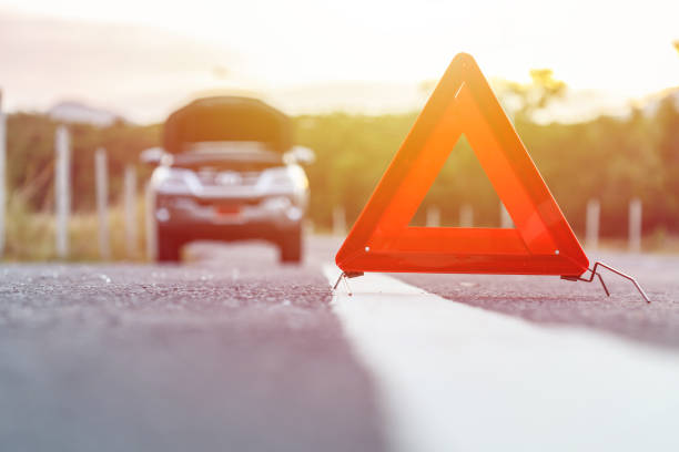 istock Red emergency stop sign and broken silver car on the road 673552500