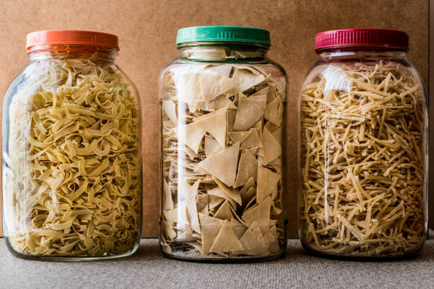 Raw spaghetti ravioli and noodle in glass bottle. Organic Food Concept.