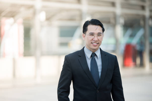 istock Good looking Asian business man standing with formal suit. 673559264