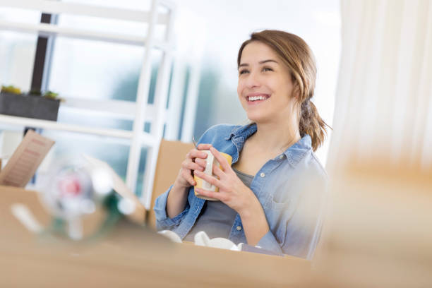 istock Young woman moves into a new home 673559962