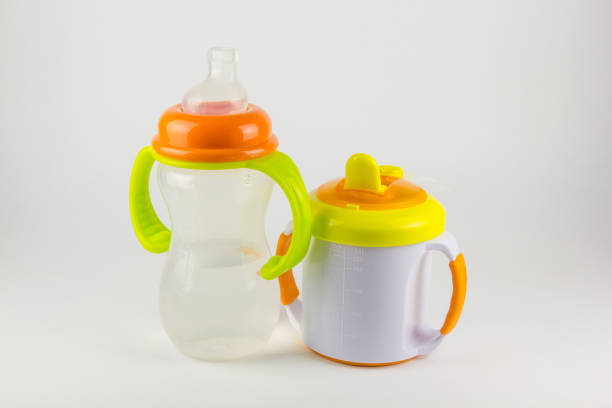 istock Baby bottles with water on white background 673562944
