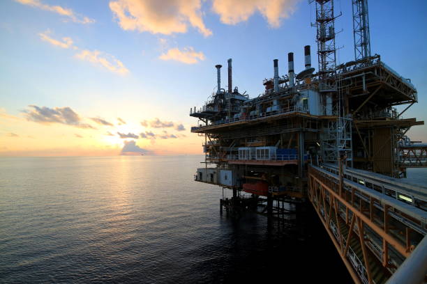 istock Offshore construction platform for production oil and gas with sunset sky 673567006