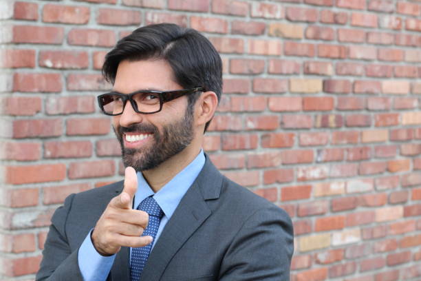 Cheesy Businessman Pointing at YOU Cheesy Businessman Pointing at YOU. cheesy grin photos stock pictures, royalty-free photos & images
