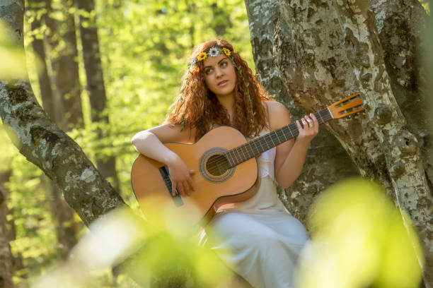 istock Girl  playing guitar 673571434