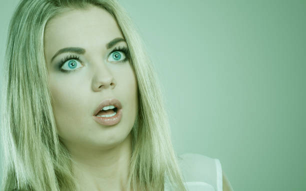 istock Surprised shocked woman face with open mouth 673571524