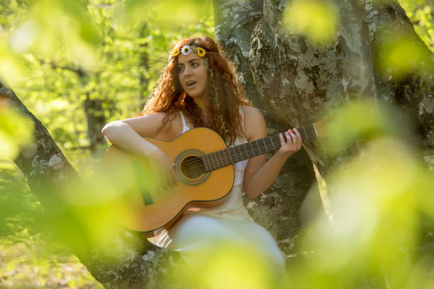 istock Girl  playing guitar 673571608