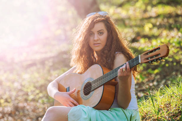 istock Girl  playing guitar 673573960