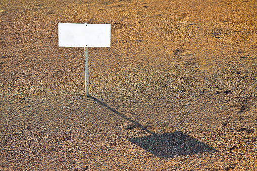 A blank advertising billboard on a gravel soil - image with copy space