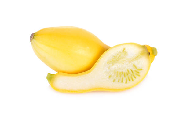 whole and half cut fresh squash crookneck on white background