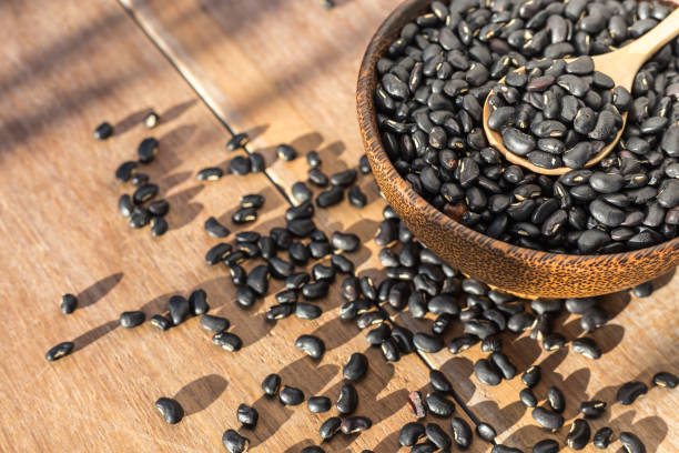istock Black bean in bowl on wooden table background 673589082