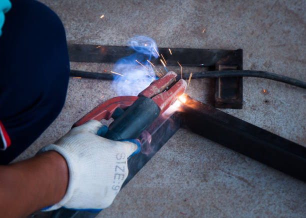 istock Worker welding steel with sparks using mig mag welder 673589290