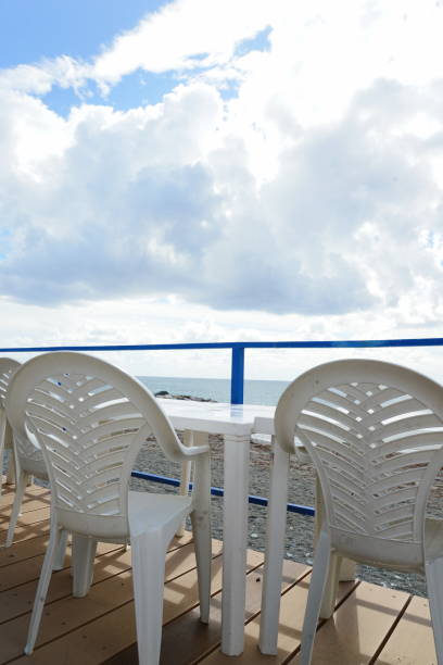istock sea landscape with stormy clouds and plastic chair 673589626