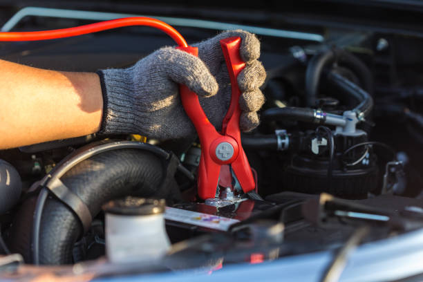 istock Hand of car technician holding cable to connect to battery 673592746