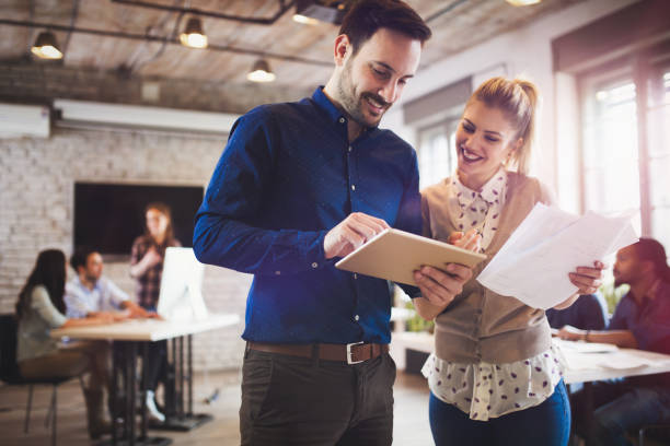 istock Company coworkers working in office and sharing new ideas 673592950