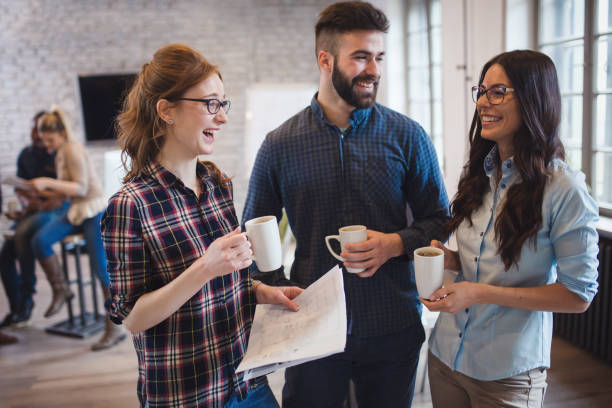 istock Coworking colleagues having conversation at workplace and sharing ideas 673593058
