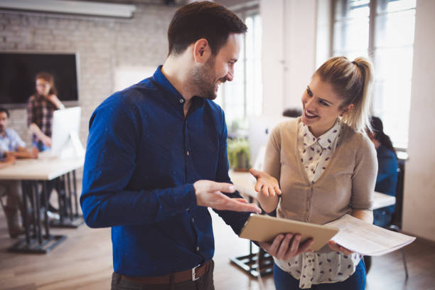 istock Successful happy coworkers communicating in modern company office 673593160