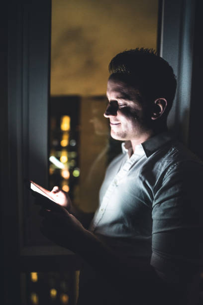 istock man looking the phone at night in the bedroom 673596410