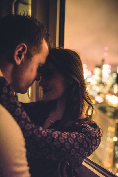 istock Couple flirting in a darkroom face to face 673597162