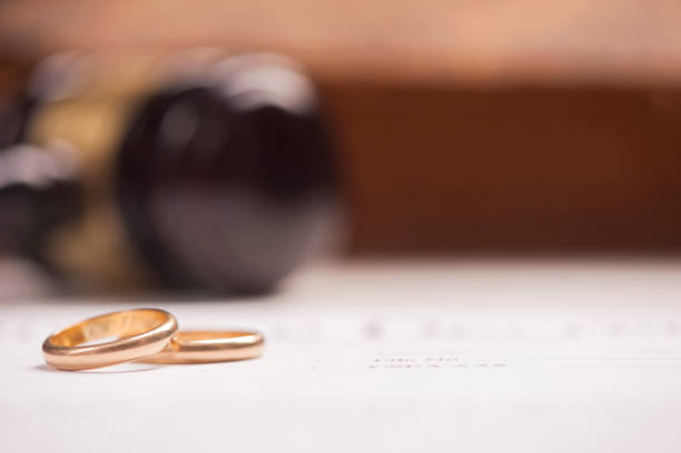 istock Wedding Rings And Wooden Gavel 673603612