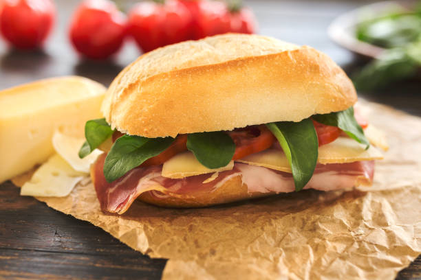 istock One delicious sandwich some tomatoes in the background 673604570