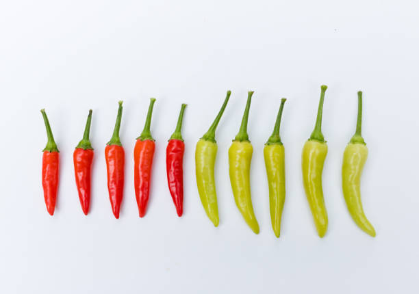 istock Close up green and red chili pepper on white background. 673607010