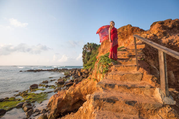 istock Woman in a sari on Sri Lanka beach. 673607594