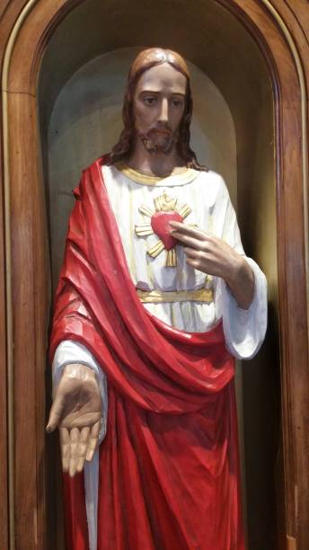 istock Jesus Christ Touching Merciful Heart and Extending Hand 673622318