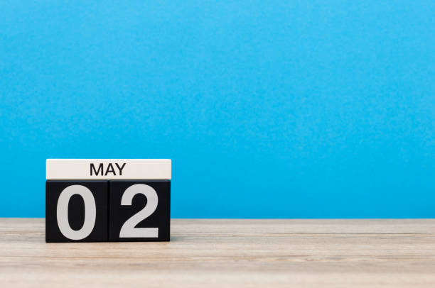 istock May 2nd. Day 2 of month, calendar on blue background. Spring day, empty space for text. last spring month 673632760