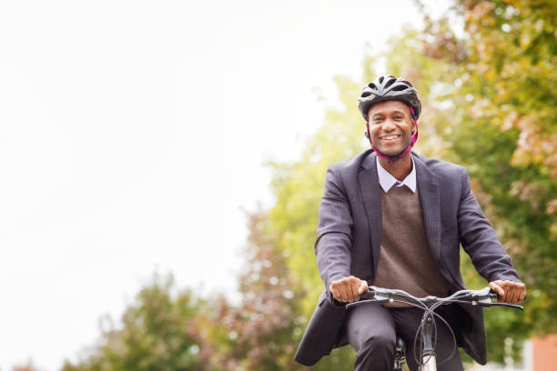 istock Single black male in his 30s smiling as he cycles to work 673640856