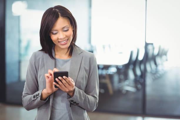 istock Attractive businesswoman using mobile phone 673643390