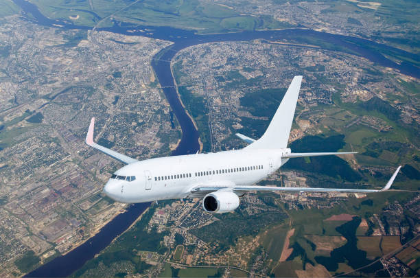 istock Aircraft at flight level, flying over the city landscape river 673643608