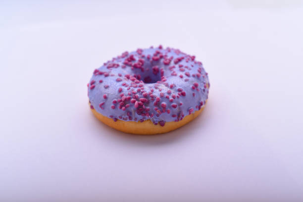 istock Purple donut with chocolate sprinkles 673648092