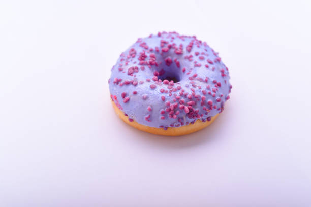 istock Purple donut with chocolate sprinkles 673648186