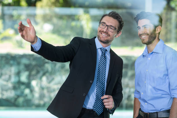istock Real estate agent showing property to a man 673648350